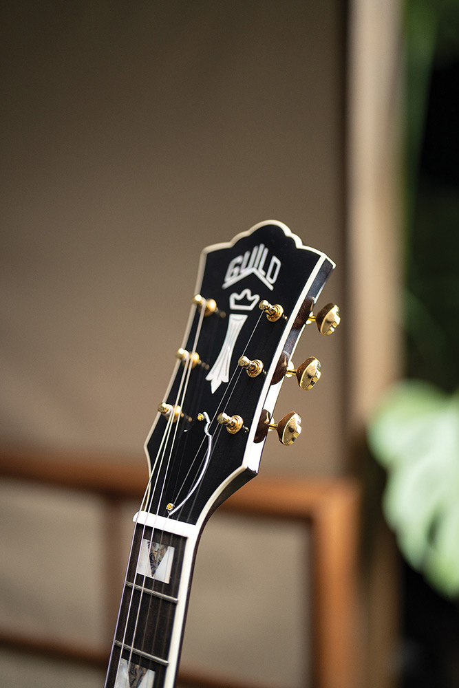 Close-up of the headstock on a Starfire Custom DC GVT GH, showing the Guild Peak and Chesterfield inlays and Grover open-gear tuners.