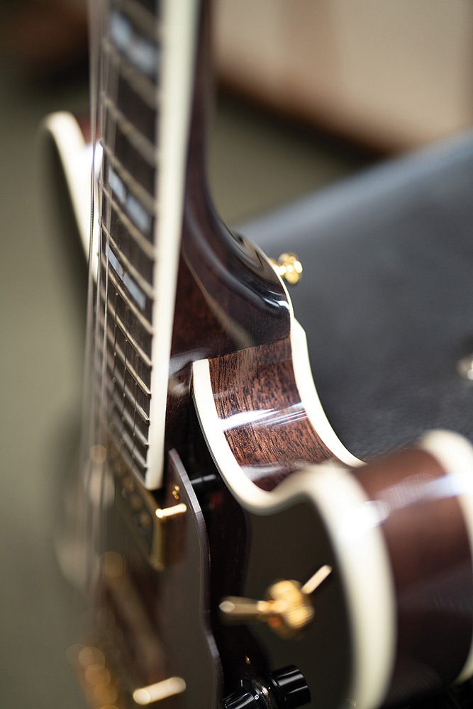 Close-up of the neck meeting the body on a Starfire Custom DC GVT GH, showing the bound ebony fingerboard and a mother-of-pearl V-block inlay.