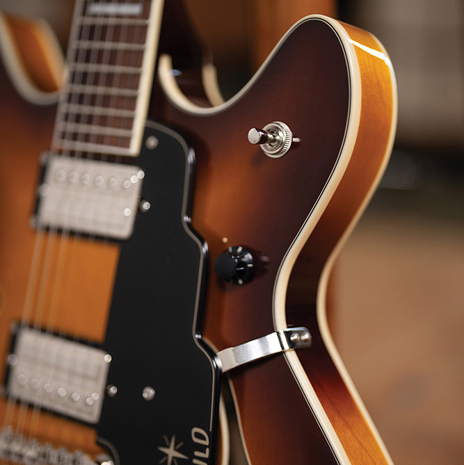 Close-up of the fingerboard and pickup selector switch on a Starfire Deluxe DC Sweet Tea, showing the block inlays and ivory binding.