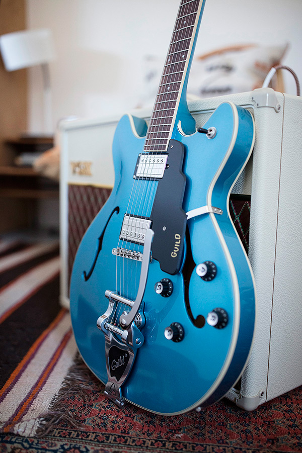 Thumbnail view of Starfire I DC Pelham Blue leaning against an amp in a cozy room