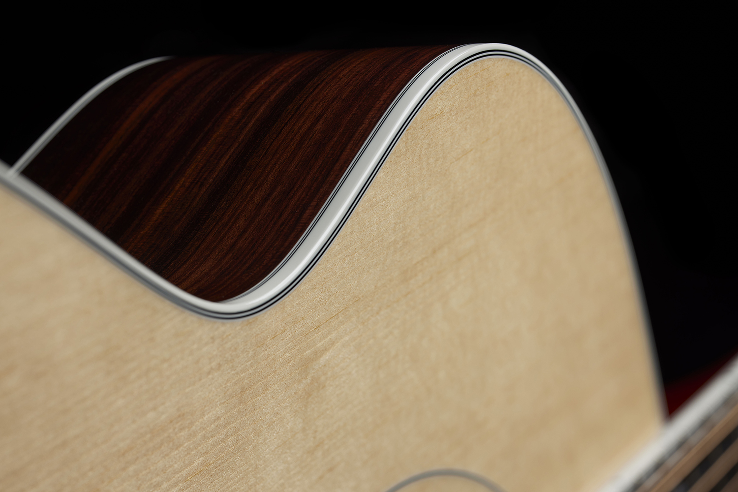 Close-up of F-512E Natural curve and binding of the acoustic guitar's body.