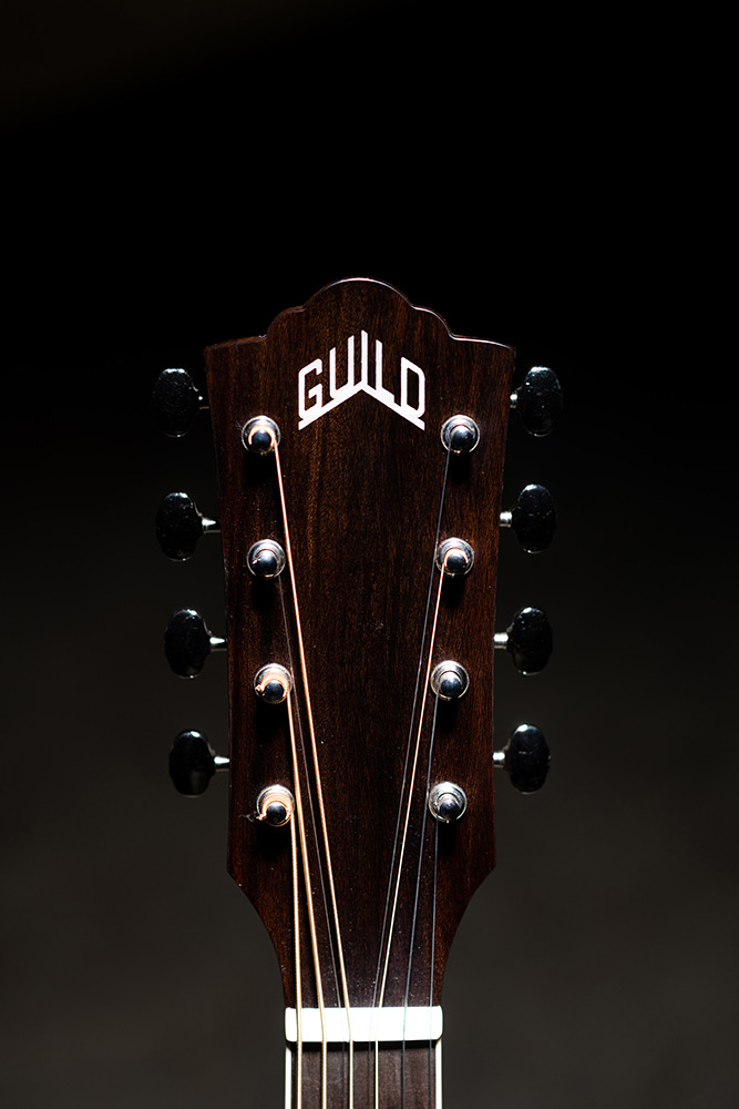 Close-up BT-258E Deluxe Baritone Natural Arched headstock with Guild logo