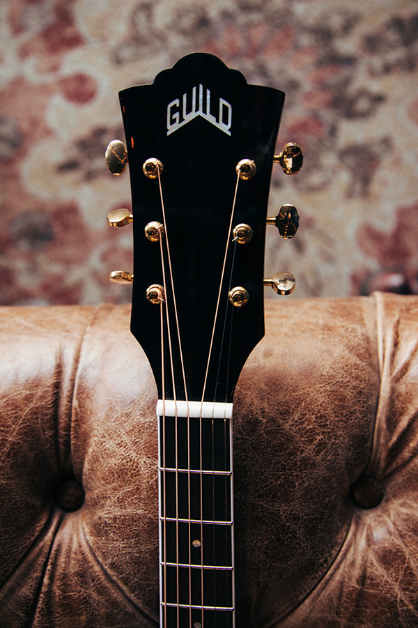 Close-up F-250E Deluxe Archback Blonde headstock with Guild logo