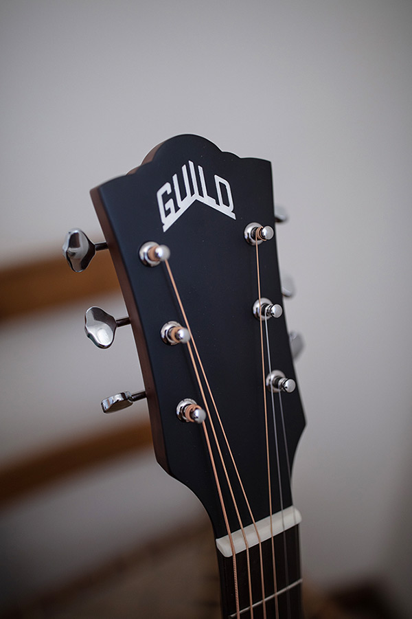 Close-up of OM-240E Natural headstock with Guild logo