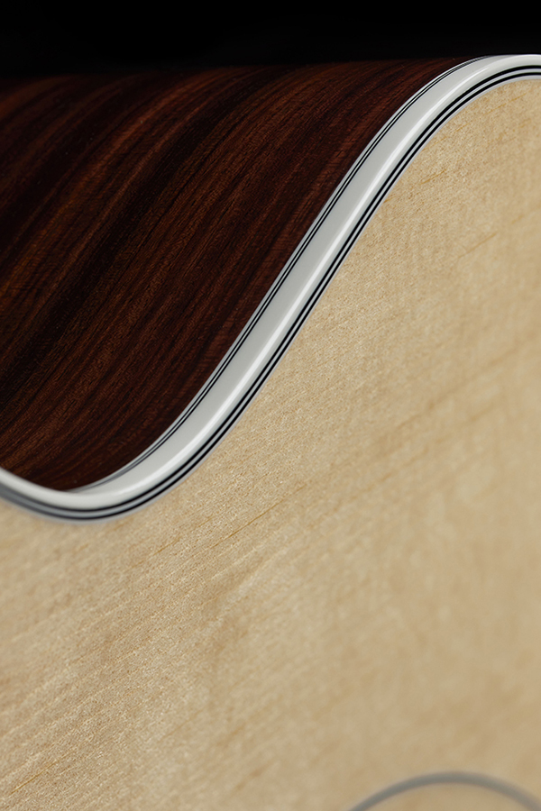 Close-up of F-512E Natural curve and binding of the acoustic guitar's body.