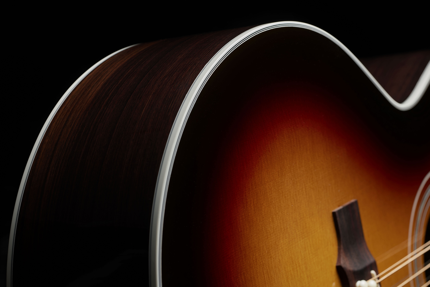 Close-up of F-512E Antique Burst curve and binding of the acoustic guitar's body.