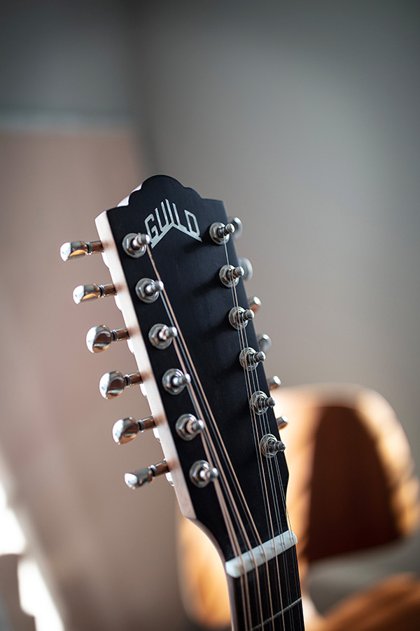 Close-up F-2512E Maple headstock with Guild logo