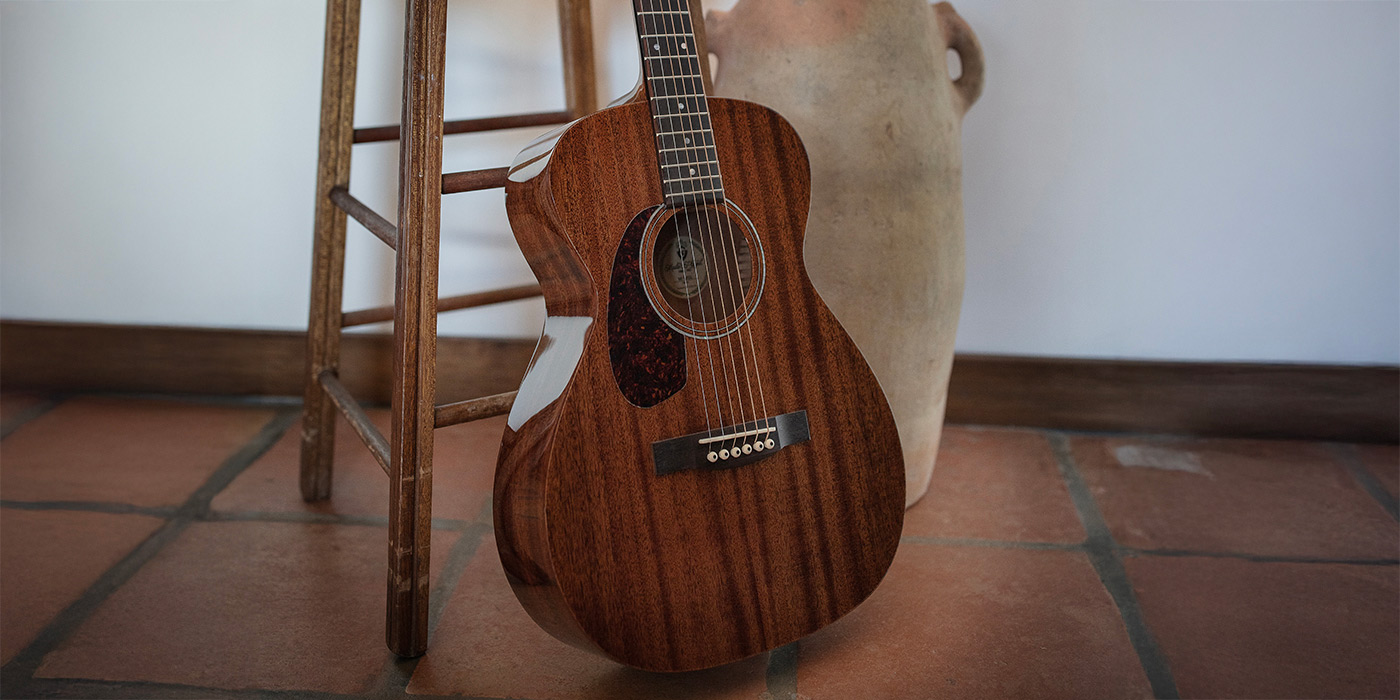M-120 leaning against wood stool on a tile floor