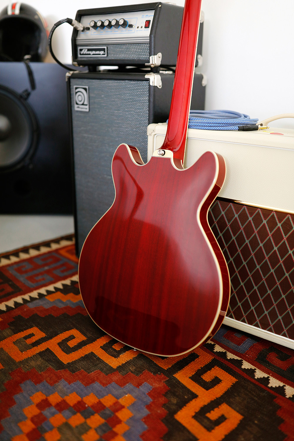 Starfire I DC Cherry red back of guitar leaning against an amp in a cozy room