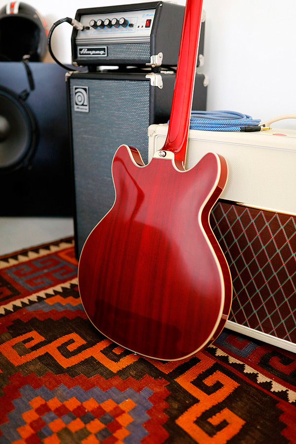 Thumbnail view of Starfire I DC Cherry red back of guitar leaning against an amp in a cozy room