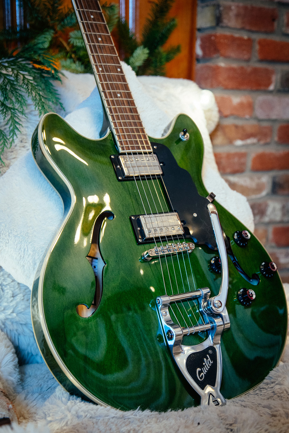 Starfire I DC Emerald Green body leaning against a fluffy white chair in a cabin