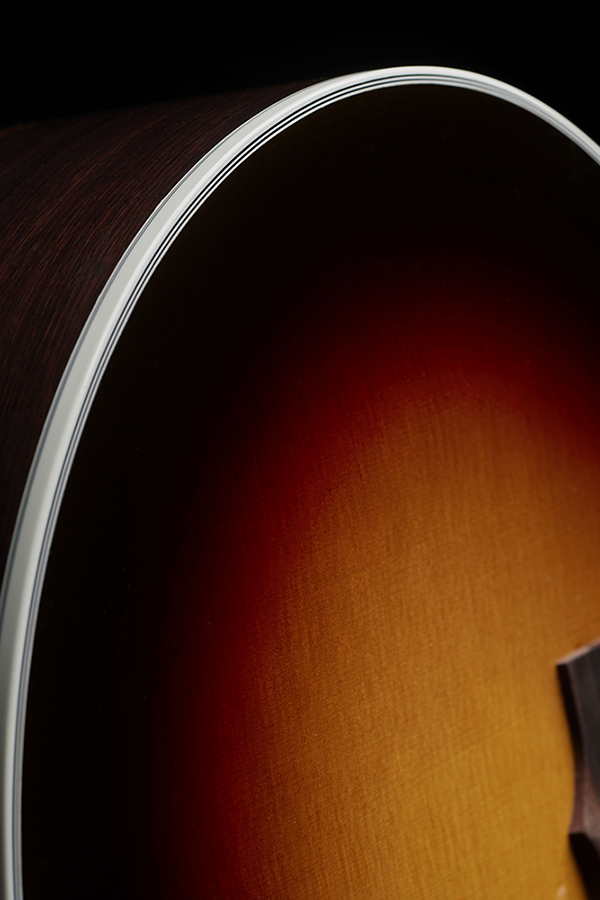Close-up of F-512E Antique Burst curve and binding of the acoustic guitar's body.
