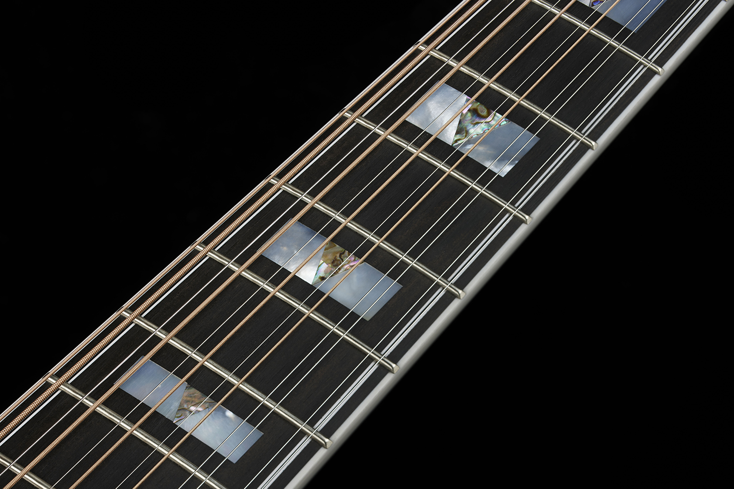 Close-up of F-512E guitar neck showing fretboard inlays and strings.