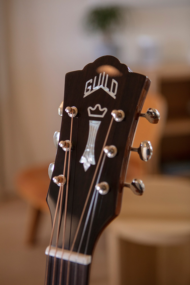 Close up of D-120 headstock with Guild Peak logo