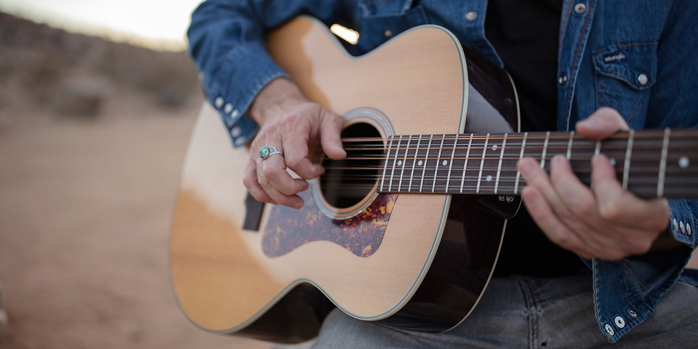 Close up of F-1512 acoustic guitar being played