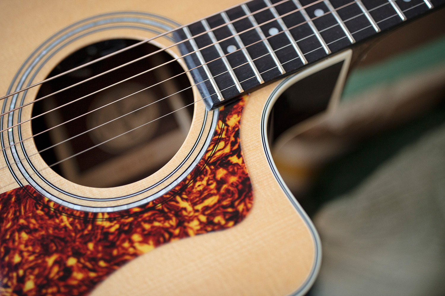 Close up of OM-150CE Natural soundhole and pickguard