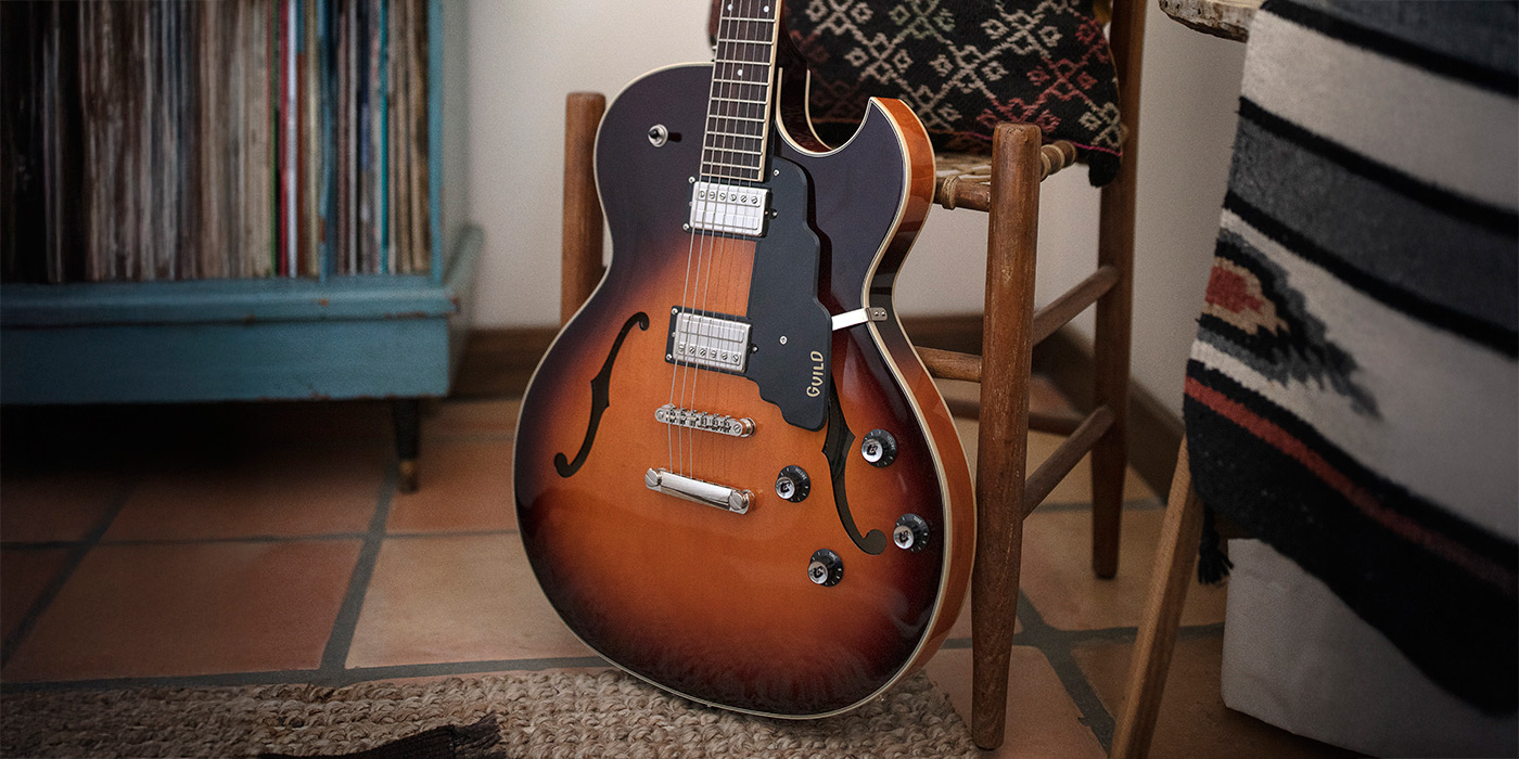 Starfire I SC Antique Burst leaning against a wood chair by a record cabinet