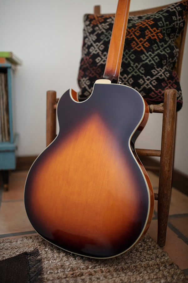 Thumbnail view of Starfire I SC Antique Burst leaning backwards against a wood chair in a cozy room