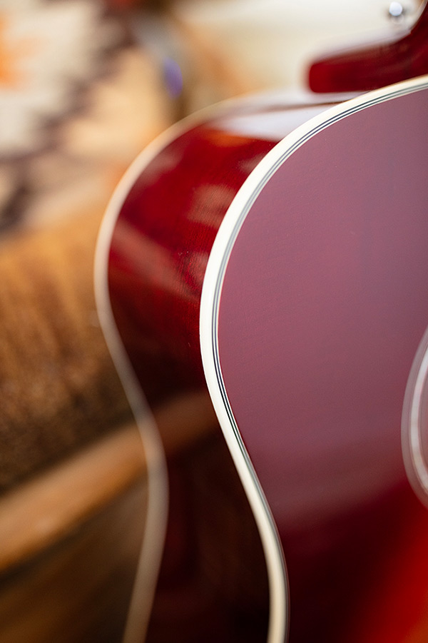 Close up of D-140 Cherry Burst body curve showcasing Solid Sitka Spruce top thumbnail