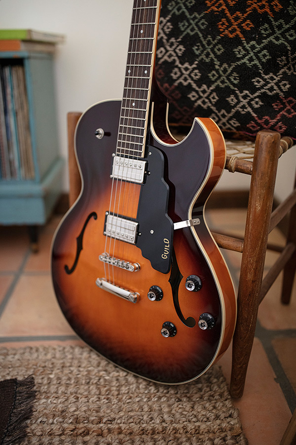 Thumbnail view of Starfire I SC Antique Burst leaning against a wood chair by a record cabinet