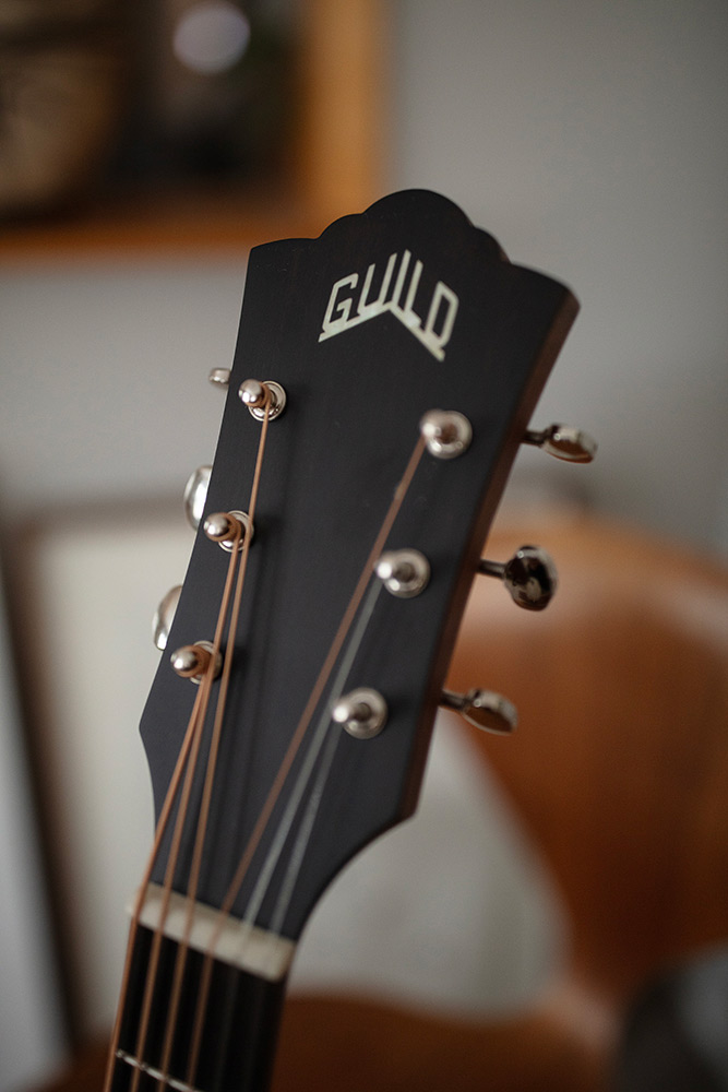 Close up of BT-240E Baritone Natural headstock showing Guild logo