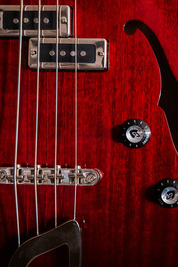Starfire I Cherry Red close-up of pickups, knobs, and f hole thumb