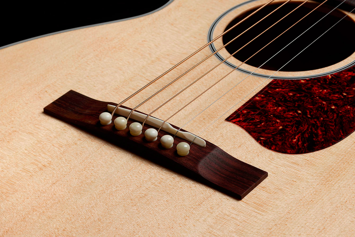 Close-up of the M-40 Standard Natural Indian rosewood bridge