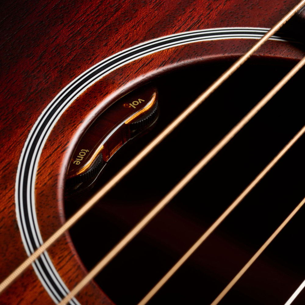 Close-up of M-20E Vintage Sunburst soundhole featuring L.R. Baggs Element VTC pickup system thumb