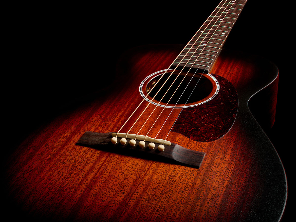Top down front view of M-20E Vintage Sunburst acoustic guitar showcasing solid African mahogany top