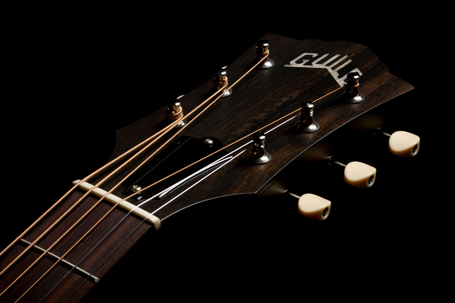 Close-up of the front of the M-20 Vintage Sunburst headstock