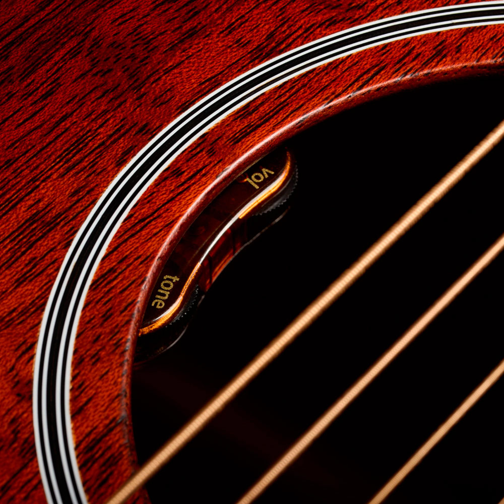 Close-up of D-20E Vintage Sunburst soundhole featuring L.R. Baggs Element VTC pickup system thumb