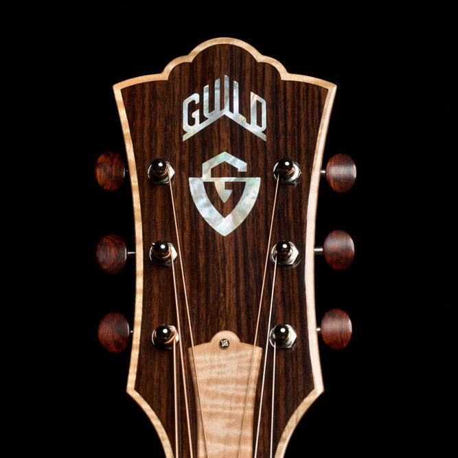 Close-up of VR1 F-40 Au Naturel Indian rosewood headstock overlay with mother-of-pearl Guild Peak logo and G shield inlays thumb