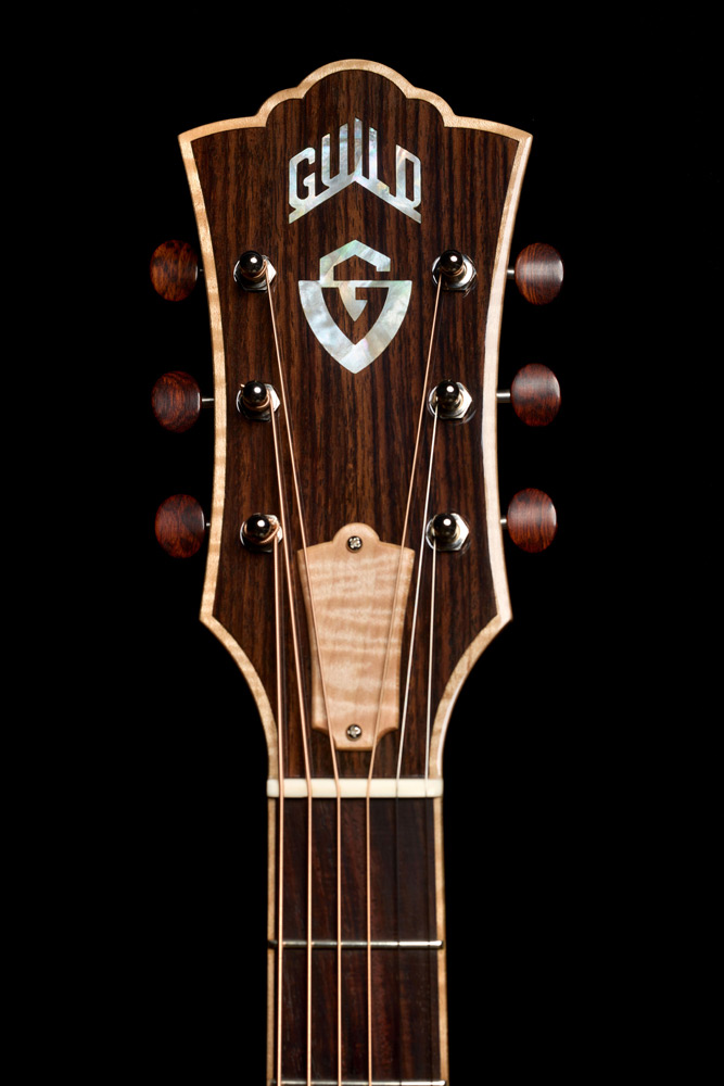 Close-up of VR1 F-40 Au Naturel Indian rosewood headstock overlay with mother-of-pearl Guild Peak logo and G shield inlays