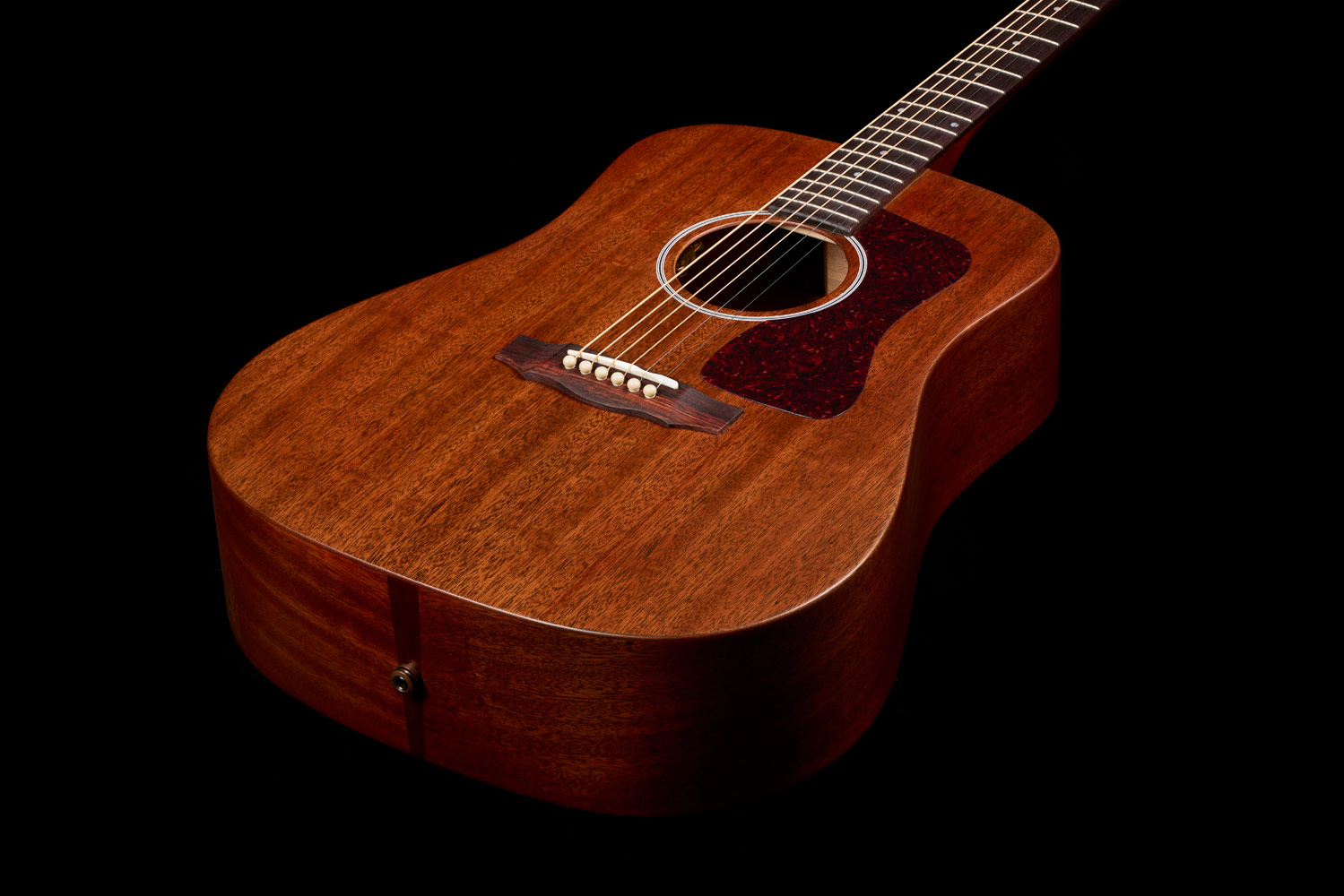 Top down front view of D-20 Natural acoustic guitar body showcasing solid African mahogany top