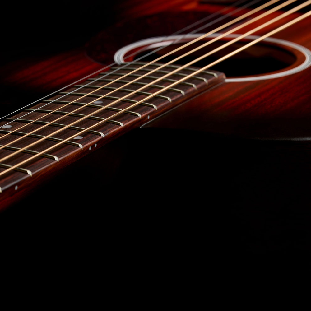 Close-up of M-20 Vintage Sunburst neck and strings thumb