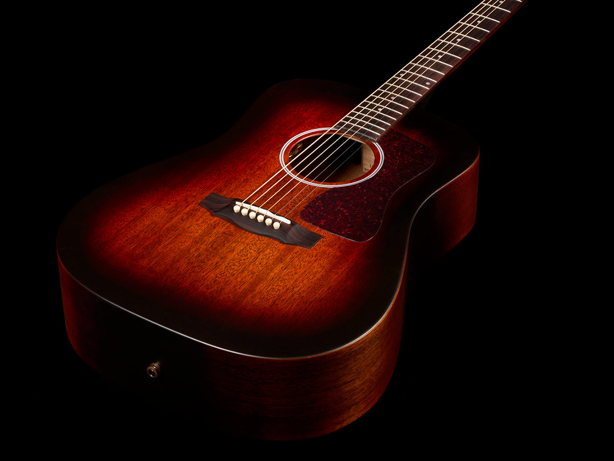Top down front view of D-20E Vintage Sunburst acoustic guitar body showcasing solid African mahogany top