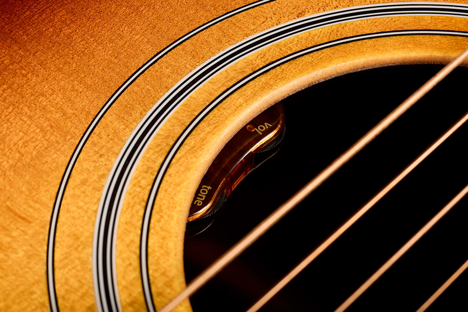 Close-up of D-50E Standard Antique Burst soundhole showcasing the L.R. Baggs Element VTC pickup system