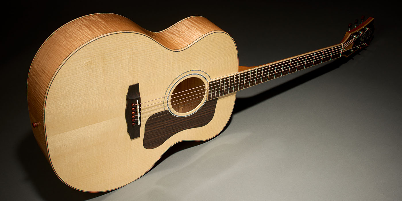 Venture Reserve VR1 F-40 Au Naturel guitar laying horizontal on gray floor