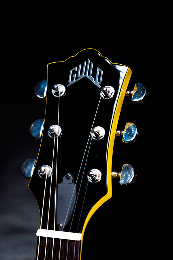Close up of Polara Voltage Yellow headstock showcasing Guild Peak Logo thumbnail