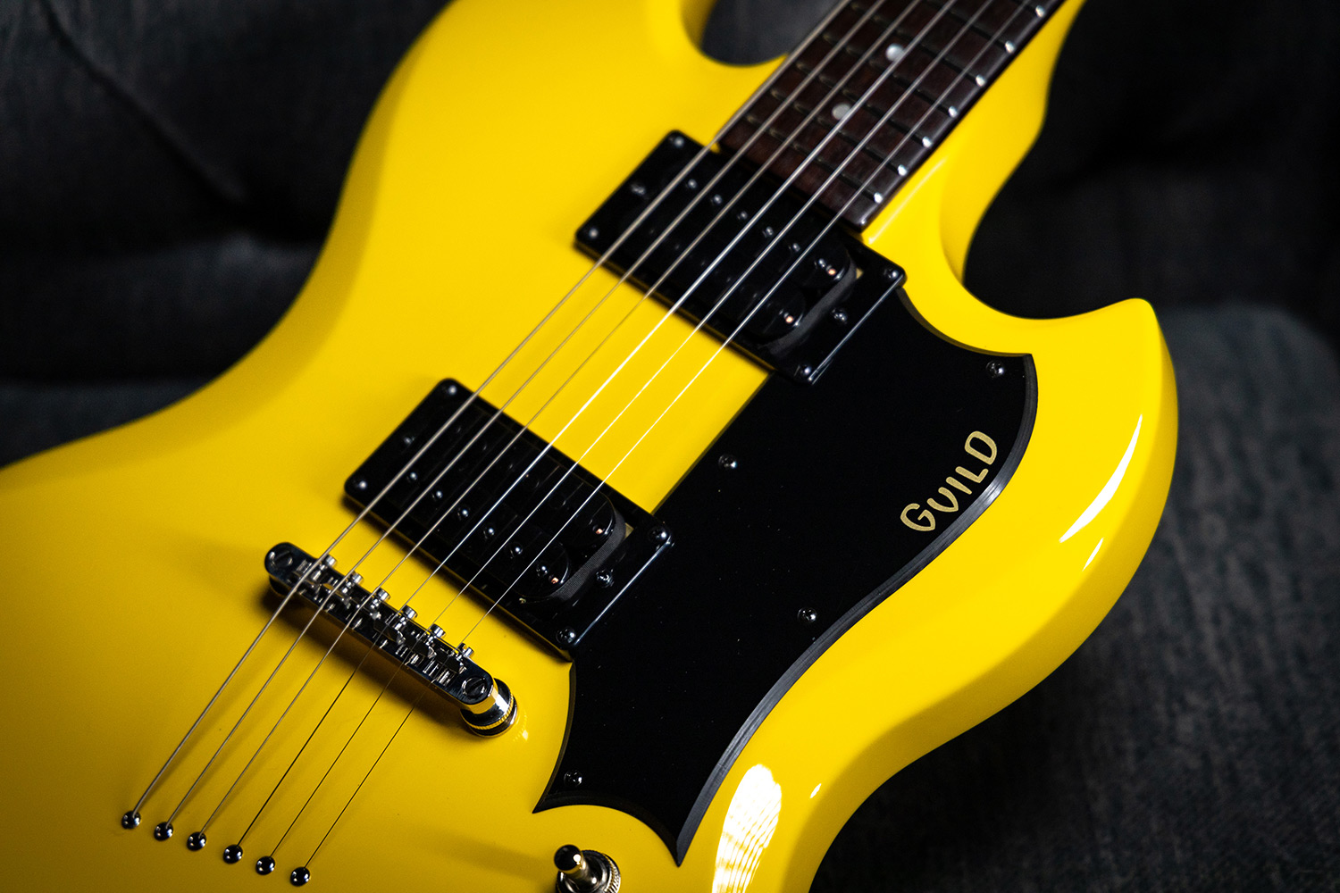 Close up of Polara Voltage Yellow pickups, bridge, and strings
