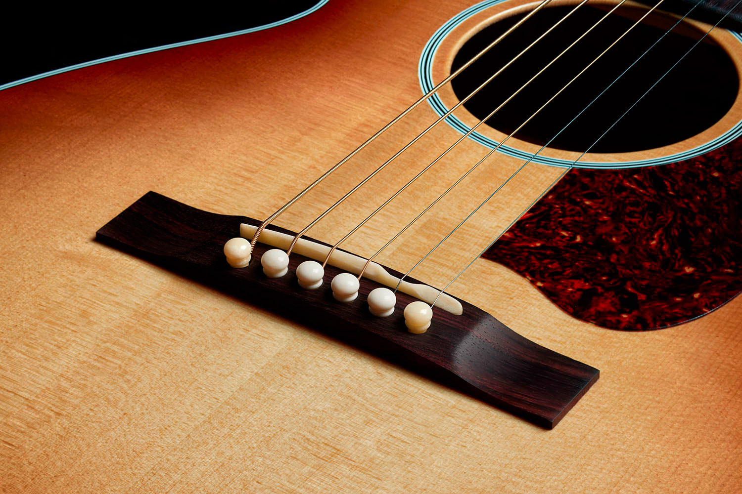 Close-up of the M-40 Standard Pacific Sunset Burst Indian rosewood bridge