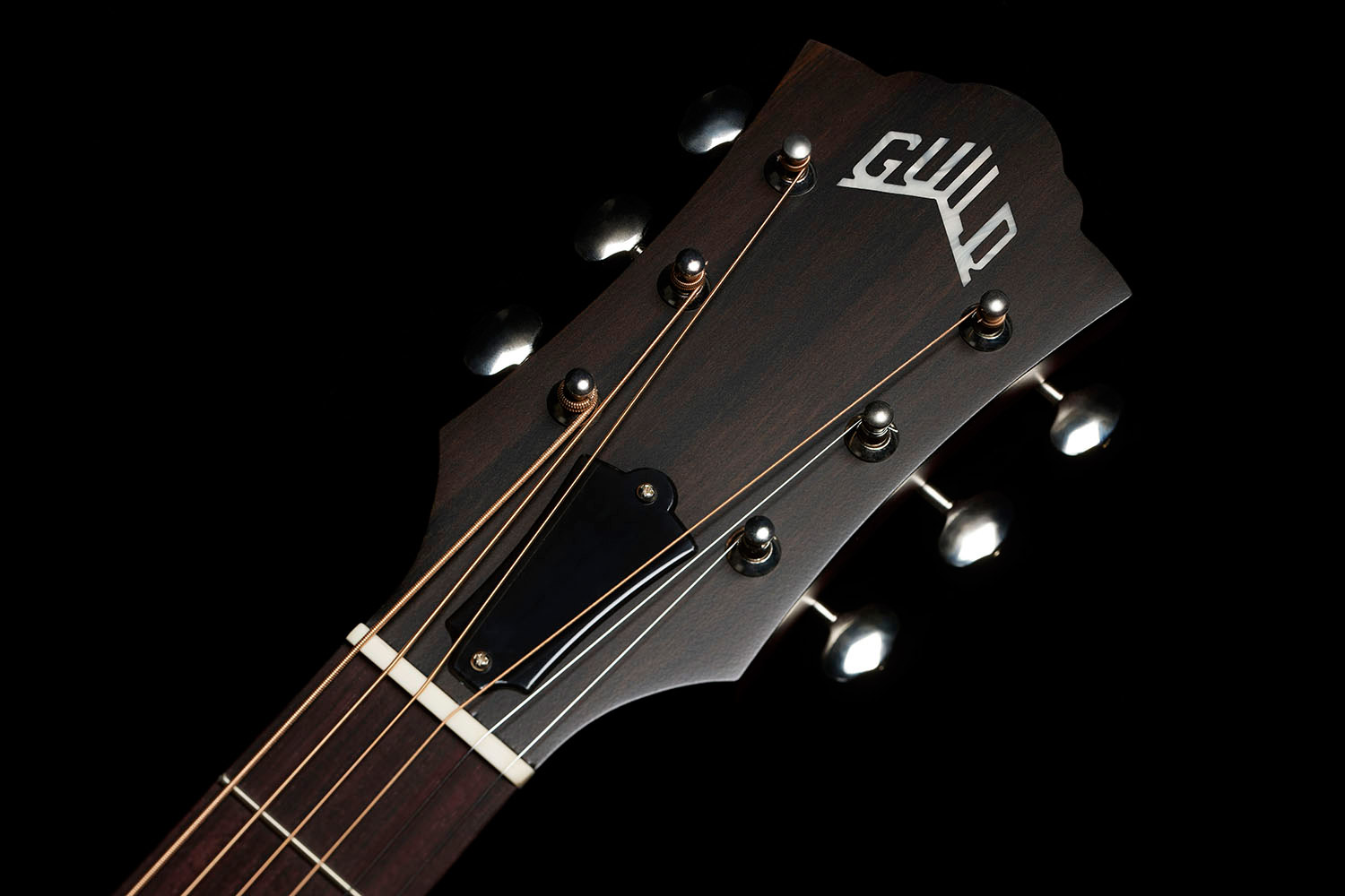 Close-up of front of the M-50 Standard Natural headstock with Guild Peak logo