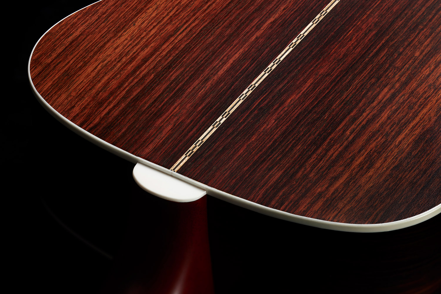 Close-up of M-50 Standard Natural heel showcasing solid Indian rosewood back and sides