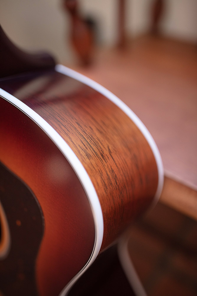 Close-up of F-40 Standard Pacific Sunset Burst shoulder featuring solid African mahogany side