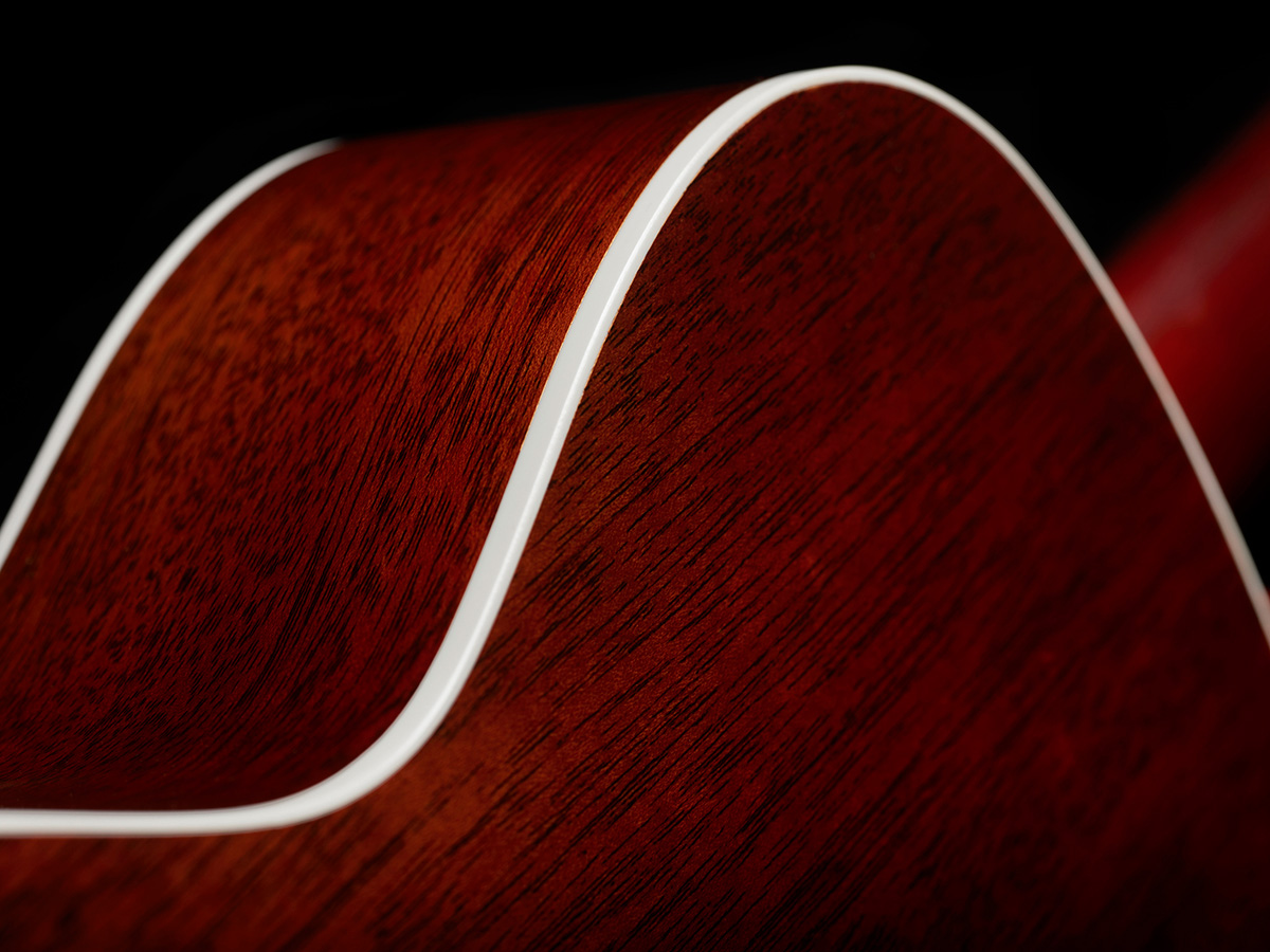 Close-up of M-40 Standard Natural white ABS body binding and solid African Mahogany back