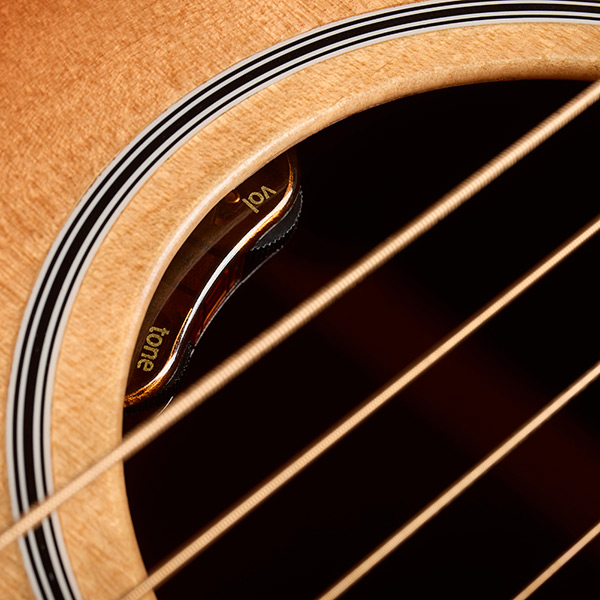 Close-up of M-40E Standard Pacific Sunset Burst soundhole showcasing L.R. Baggs Element VTC pickup system thumb