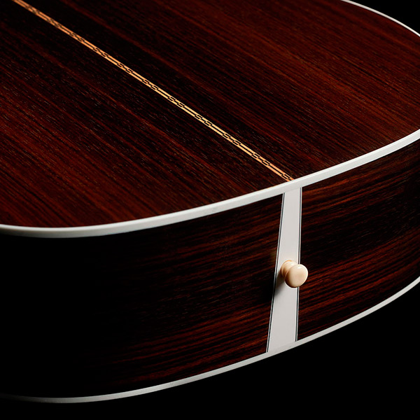 Close-up of M-50 Standard Natural back showcasing solid Indian rosewood back and strap pin thumb