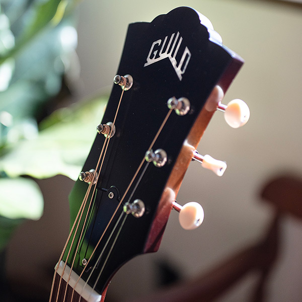 Close-up of F-40 Standard Pacific Sunset Burst headstock with Guild peak logo thumb