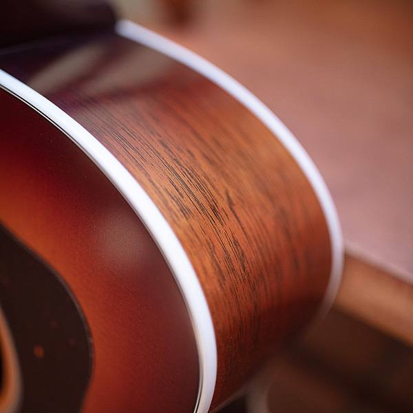 Close-up of F-40 Standard Pacific Sunset Burst shoulder featuring solid African mahogany side thumb
