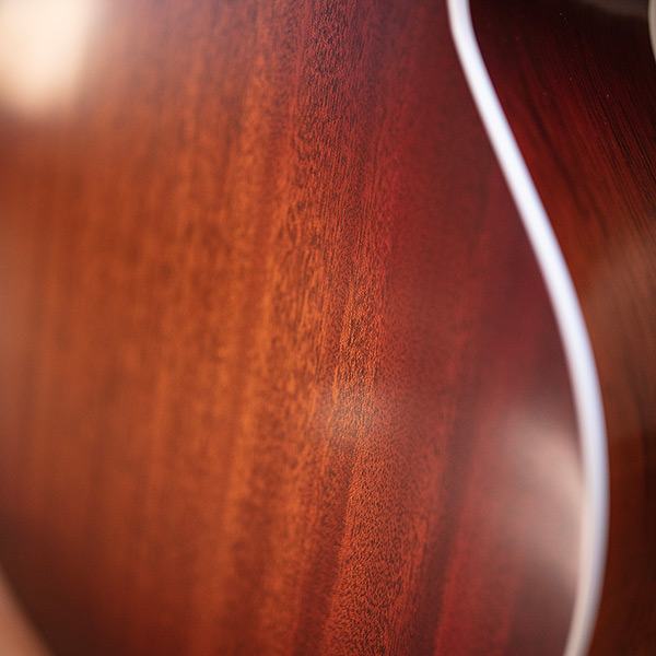 Close-up of F-40 Standard Pacific Sunset Burst body back highlighting solid African mahogany back thumb